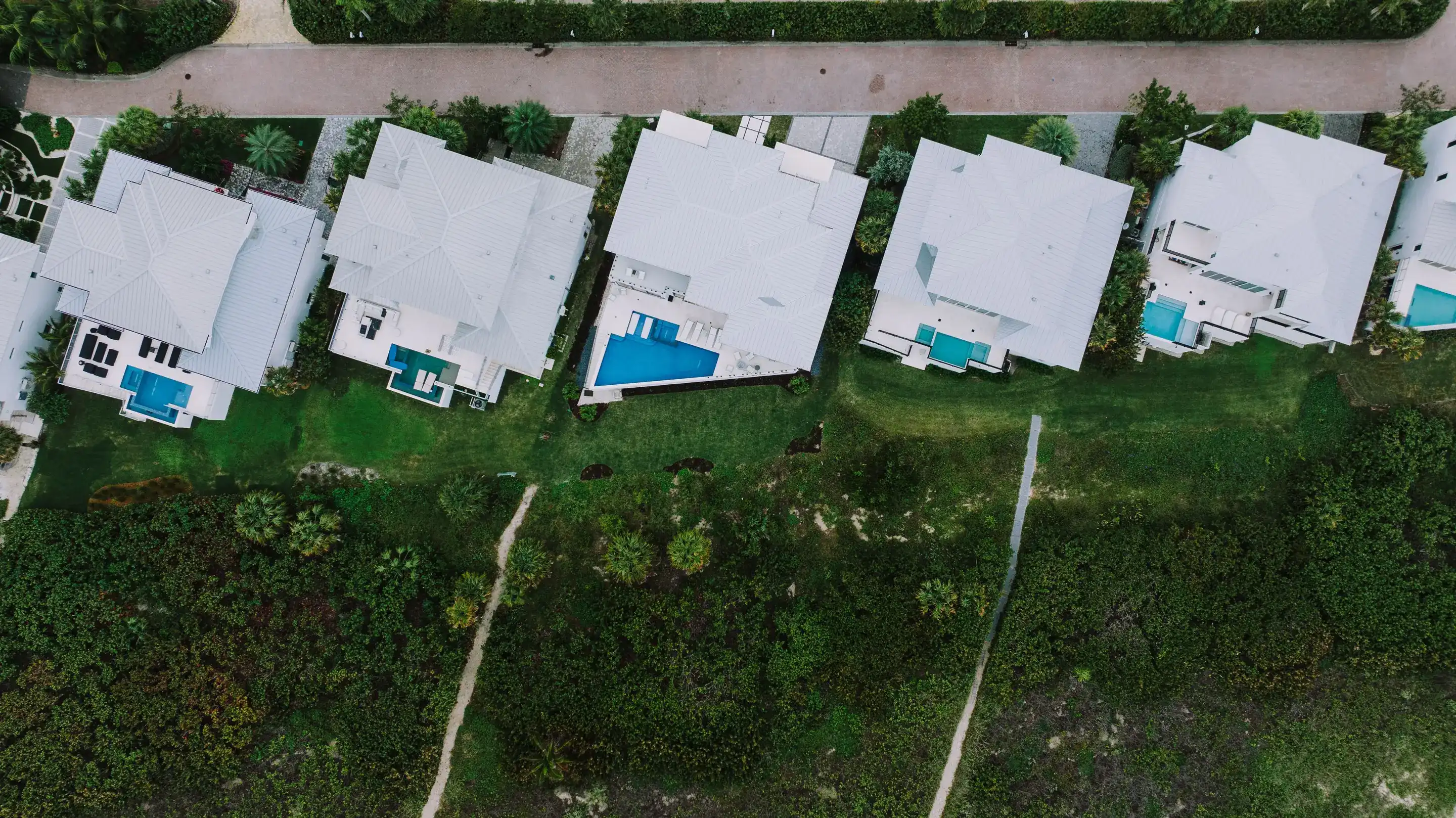 Aerial view of a suburban Florida neighborhood with pools, representative of Melbourne, FL's inland housing stock