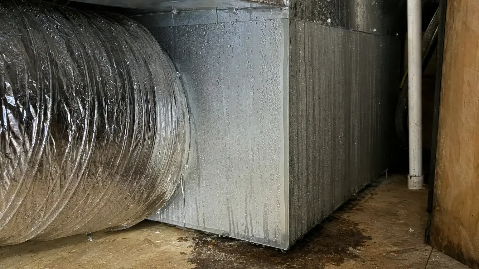 Condensation beading and running down an insulated flexible air-conditioning duct and the metal plenum of an air handler